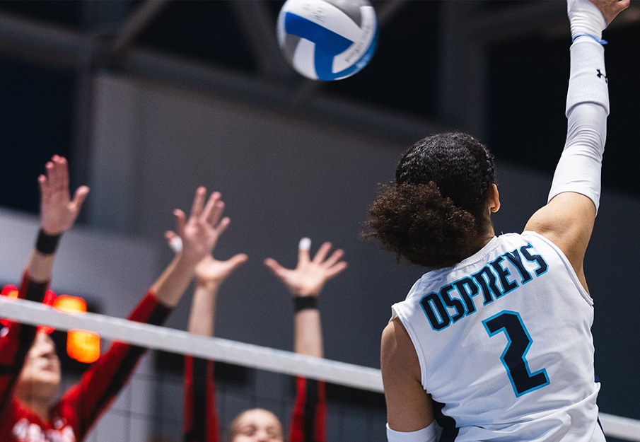 Kailey McKnight spiking a volleyball