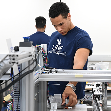 Engineering student working on a machine