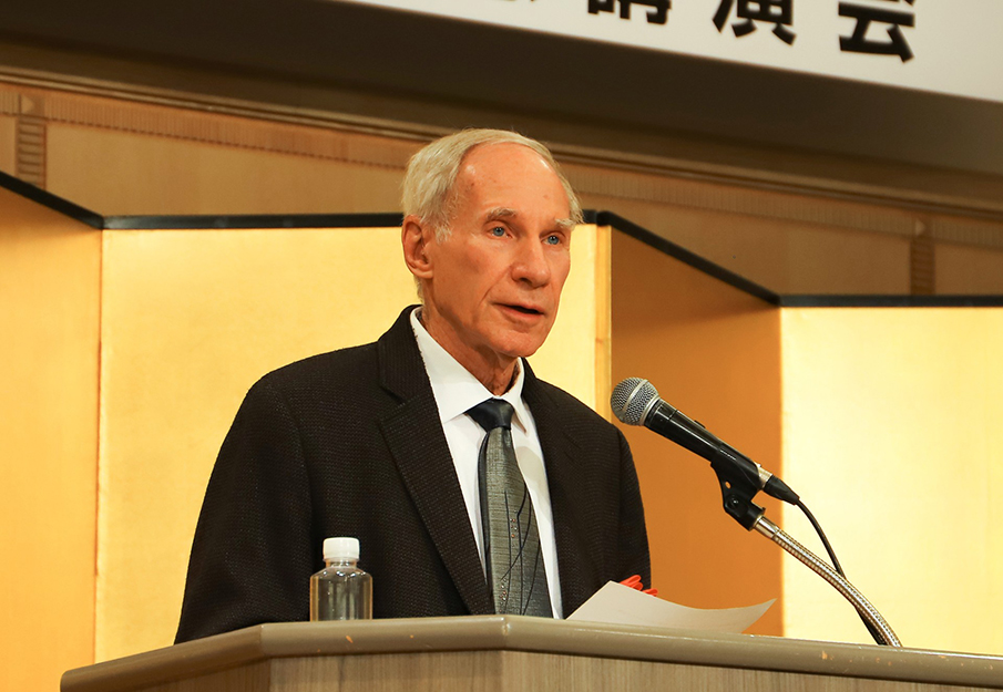 John Maraldo standing behind a podium