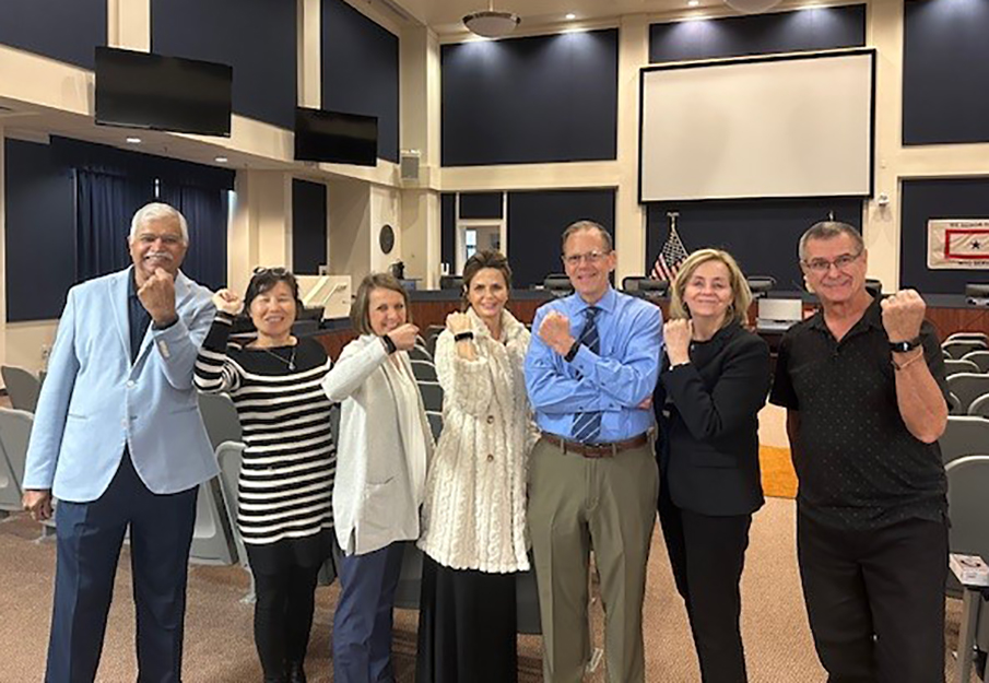 Dr. Shyam Paryani and other participants of the MedNexus veterans project standing together showing off their fitbits