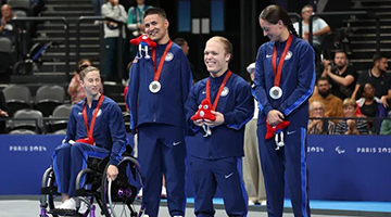 Morgan Ray (third from left) stands with US para-swimming teammates after winning the silver medal in the mixed medley relay at the Paralympics in Paris. Photo credit to Sean M. Haffey, Getty Images.