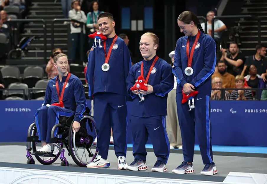 Morgan Ray (third from left) stands with US para-swimming teammates after winning the silver medal in the mixed medley relay at the Paralympics in Paris. Photo credit to Sean M. Haffey, Getty Images.