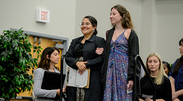 UNF student standing with one of the new US citizens recognized at the ceremony