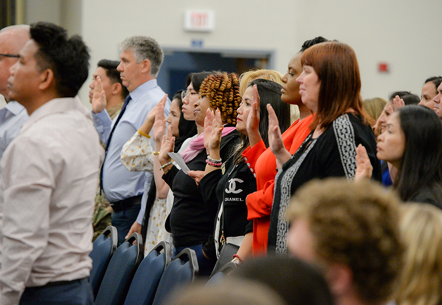 Some of the new US citizens giving their oath at the naturalization ceremony