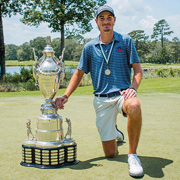 Nick Gabrelcik posing next to a trophy