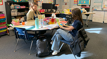 Clay County District School teacher talking with a UNF student