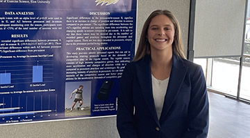 Reese Howard standing next to her presentation board