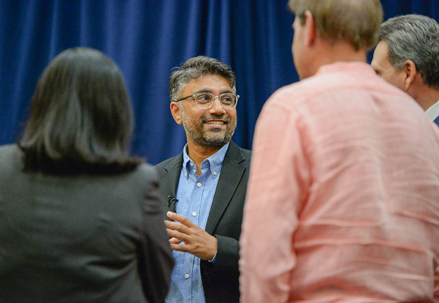 Rohan Patel talking to President Limayem and other attendees