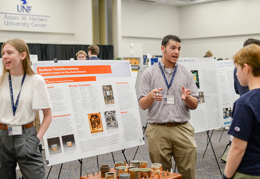 UNF student discussing his research at the SOARS Symposium