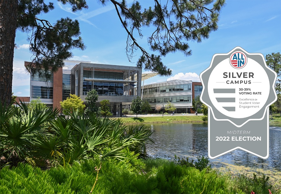 Graphic of the ALL IN Silver Seal with the Student Union in the far background