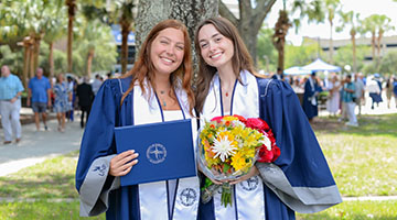 Two new UNF Grads standing beside each other