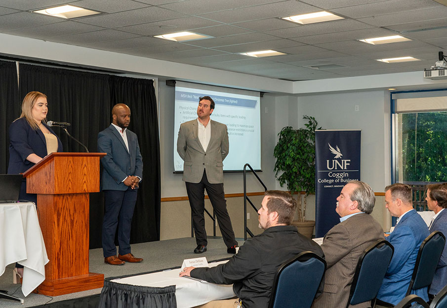 UNF students Jonathan Stephen, Shavelli Rodriguez and Richard Schultz presenting their case study solution