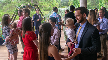 Couples who Met in the Nest holding hands as they renew their vows