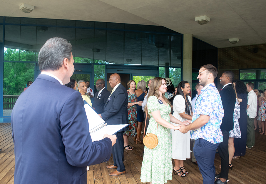 Couples who Met in the Nest holding hands as they renew their vows