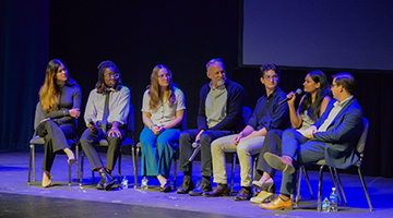 Student panel and UA professor Ted McLoof sitting on stage