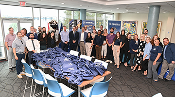 Various University of North Florida staff members, mascot Ozzie and Haskell team members posing together