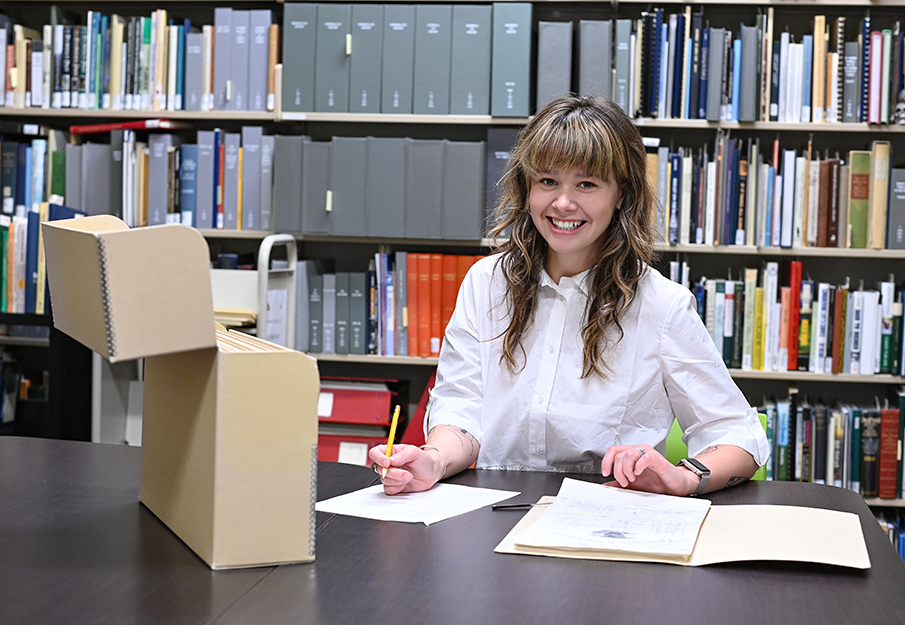 Archiving student looking at documents