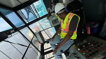 Cameron Myers in a construction machine above the city of Jacksonville