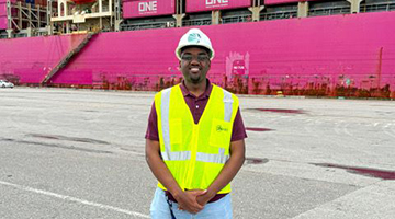 Cameron Myers standing in front of storage crates