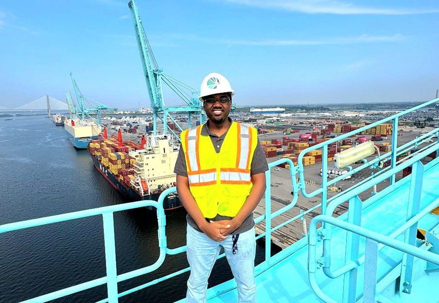 Cameron Myers standing on a platform above river