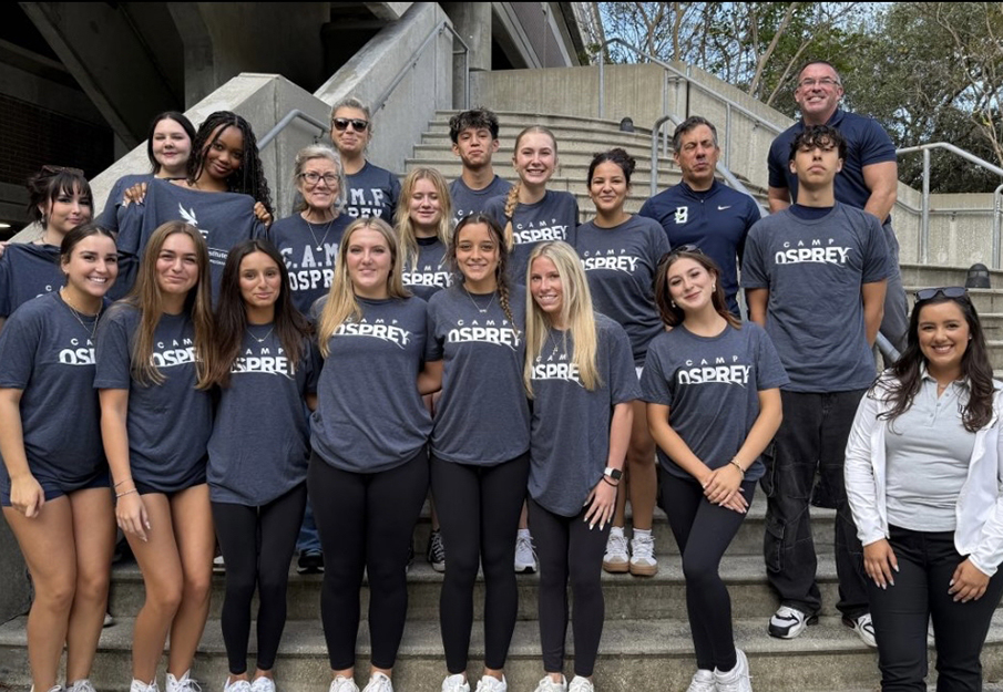 Students volunteering for CAMP Osprey standing on steps