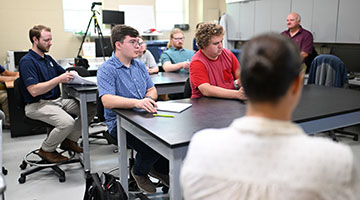 early-career apprentices and UNF students listening to a lecturer