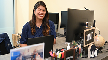 Jennifer Mendoza sitting at her desk