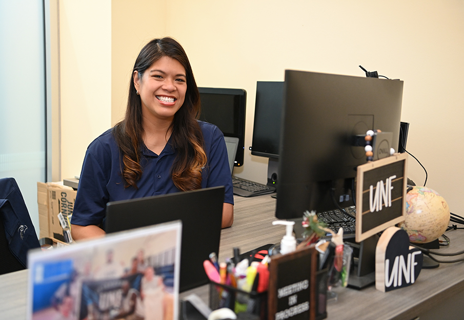 Jennifer Mendoza sitting at her desk
