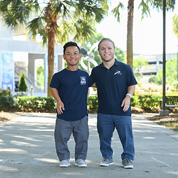 Morgan Ray and Michael Ray standing in front of arena building