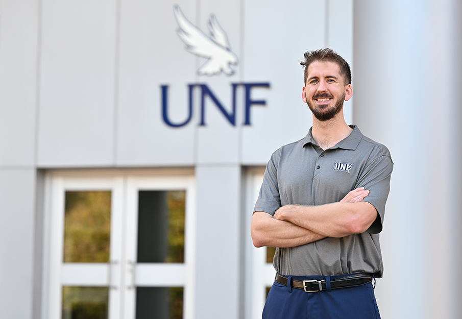 Nick Cochran headshot in front of engineering building