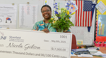 Nicola Gibson holding her check 