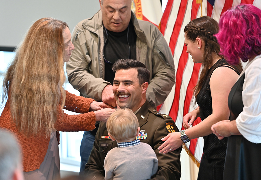 Captain Christopher Ricciardi in the middle of his family