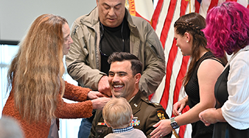 Captain Christopher Ricciardi in the middle of his family