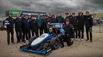 Osprey Racing team standing around car