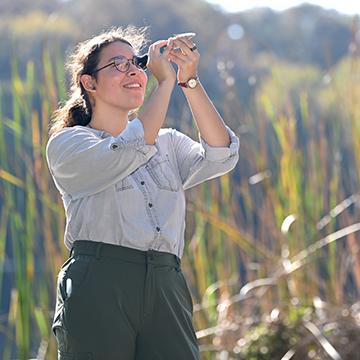 Jessie Roncevic looking at a shell