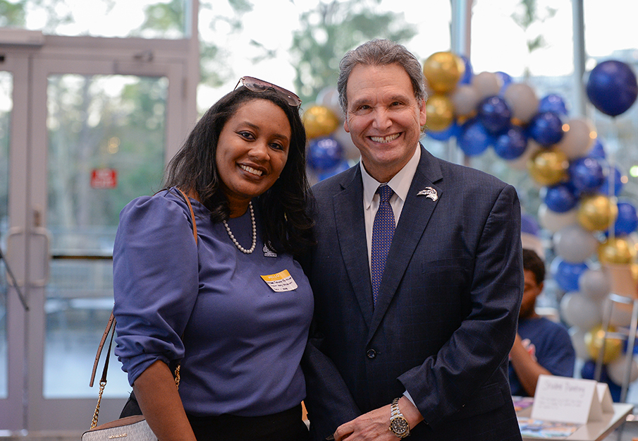UNF Alumni Rachael Tutwiler Fortune and President Moez Limayem standing together smiling