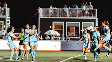 Sporting Jax playing soccer on field