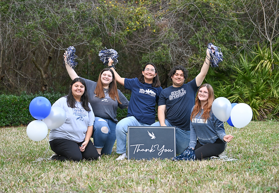 UNF students holding balloons, pompoms and a 'Thank You!' sign