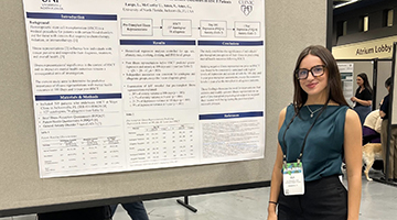 Ula McCarthy standing by her research poster