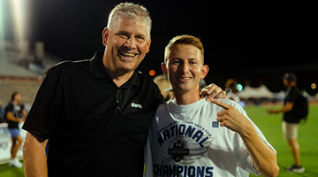 Anderson Bobo standing next to John Anderson on the UNF track and field