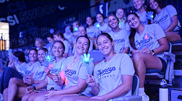 UNF volleyball team holding light up clappers