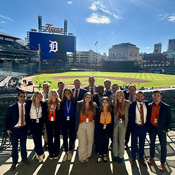 Detroit Tigers sales team standing in front of the baseball field