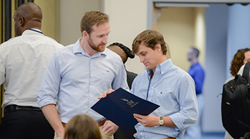Two employer representatives looking at a UNF folder