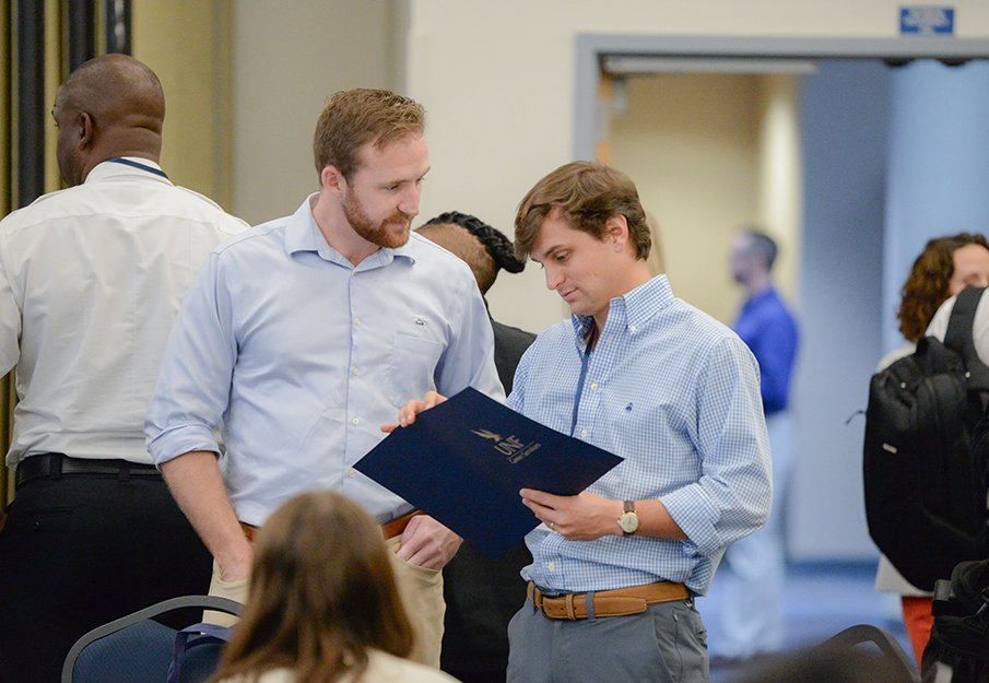Two employer representatives looking at a UNF folder