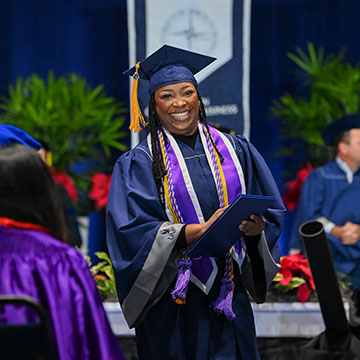 Graduate smiling at Commencement