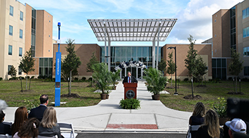 UNF President Moez Limayem speaking in front of new Honors residence hall