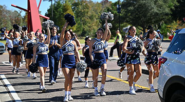 UNF cheerleaders walking in parade