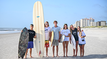 UNF Surf team posing with their surfboards