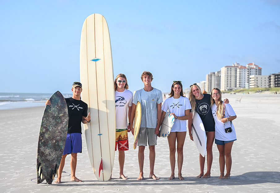 UNF Surf team posing with their surfboards