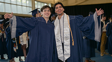 Two UNF graduates posing together